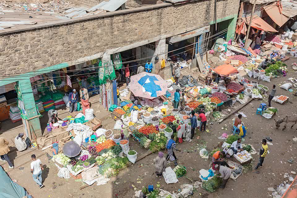 Traders and shoppers among vegetable stalls at Merkato, Addis Ababa